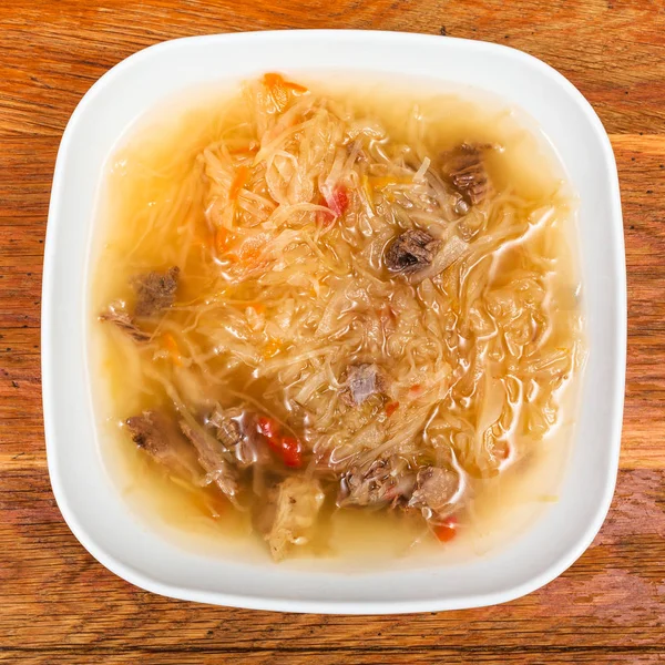 Soup with stewed sour cabbage in white plate — Stock Photo, Image
