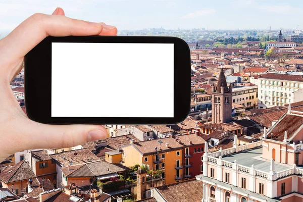 tourist photographs Verona city skyline from tower