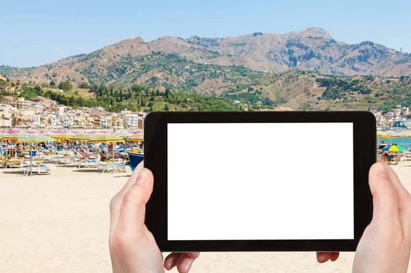 tourist photographs city beach in Giardini-Naxos