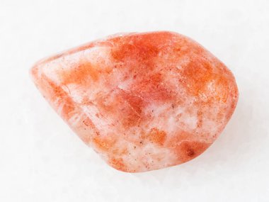 tumbled sunstone (heliolite) gemstone on white clipart