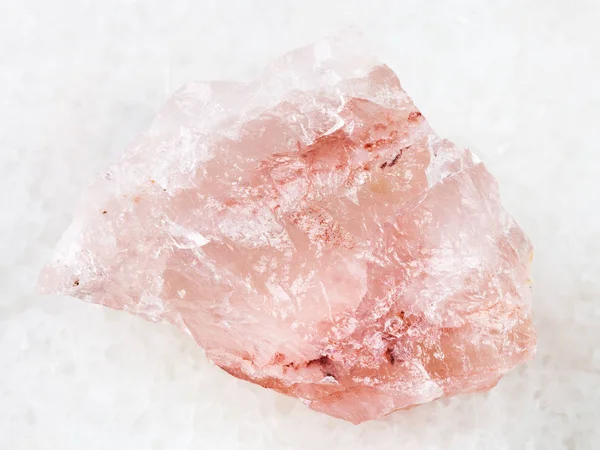 crystal of rose quartz gemstone on white