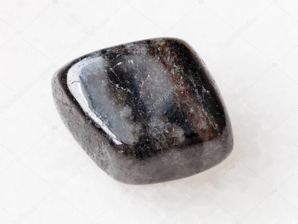 pebble of anthophyllite gemstone on white