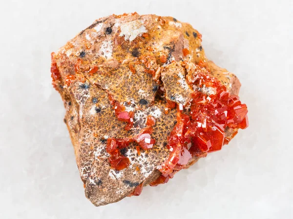 Raw crystals of Vanadinite on stone on white — Stock Photo, Image