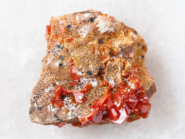 Rough crystals of Vanadinite on stone on white — Stock Photo, Image