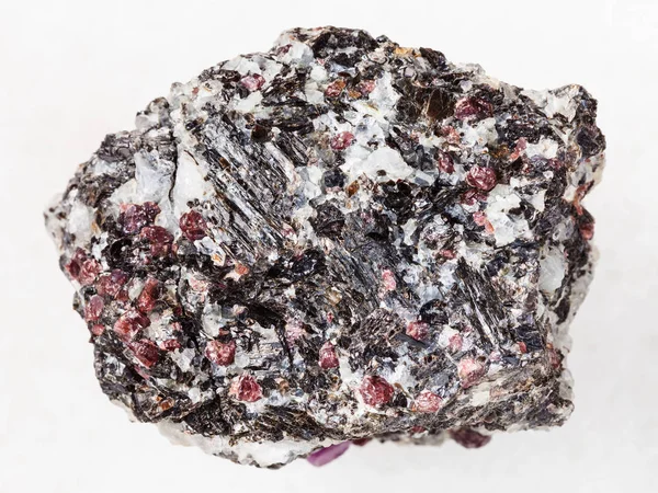 Rough gneiss stone with corundum crystals on white — Stock Photo, Image