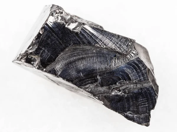 Ruwe shungite stone op wit marmer — Stockfoto