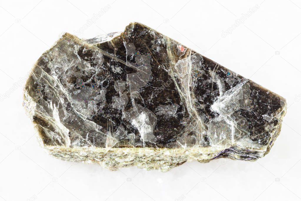 rough muscovite mica stone on white marble
