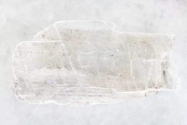 Rough crystal of Gypsum gemstone on white marble — Stock Photo, Image