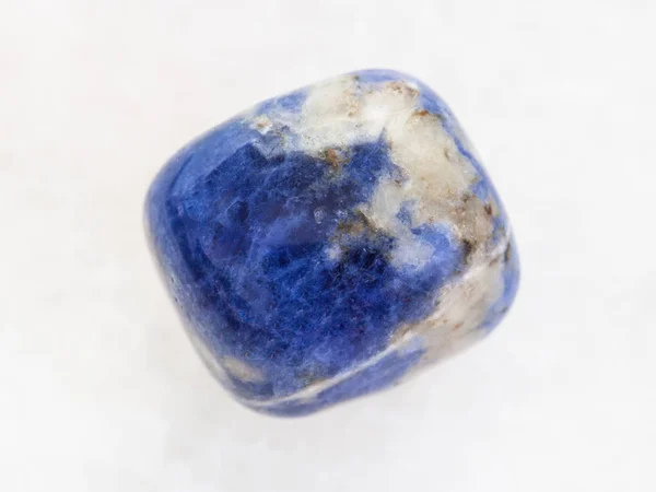 Tumbled Sodalite gemstone on white marble — Stock Photo, Image