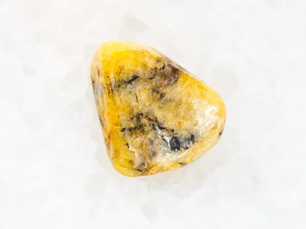Tumbled yellow Agate gemstone on white marble — Stock Photo, Image