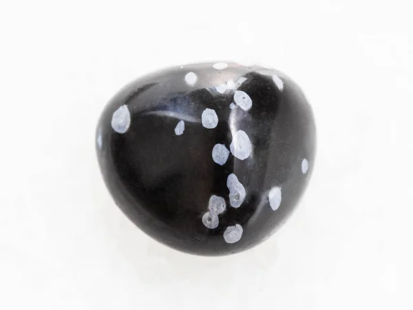Tumbled snowflake obsidian gemstone on white — Stock Photo, Image