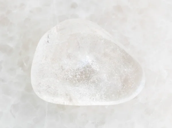 Polished Rock-crystal gem stone on white marble — Stock Photo, Image