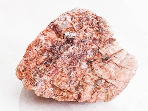Κομμάτι ροζ γρανίτη πέτρας σε λευκό μάρμαρο — Φωτογραφία Αρχείου