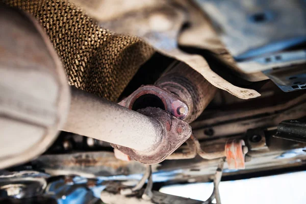 Bottom view of broken muffler on car — Stock Photo, Image