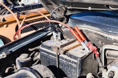 Jump start a flat car battery with another vehicle clipart