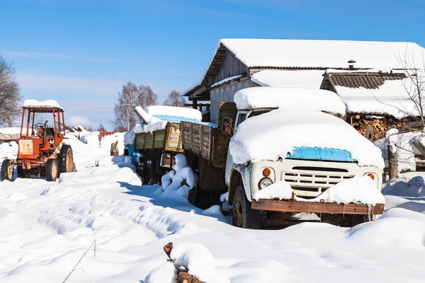 snow-covered transport on street in village