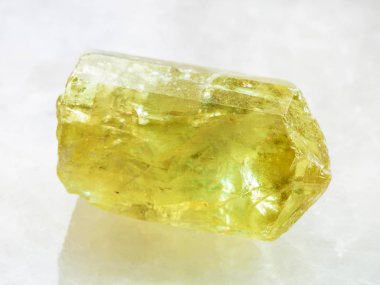 raw crystal of yellow Apatite gemstone on white clipart