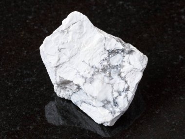 raw Howlite stone on black granite clipart