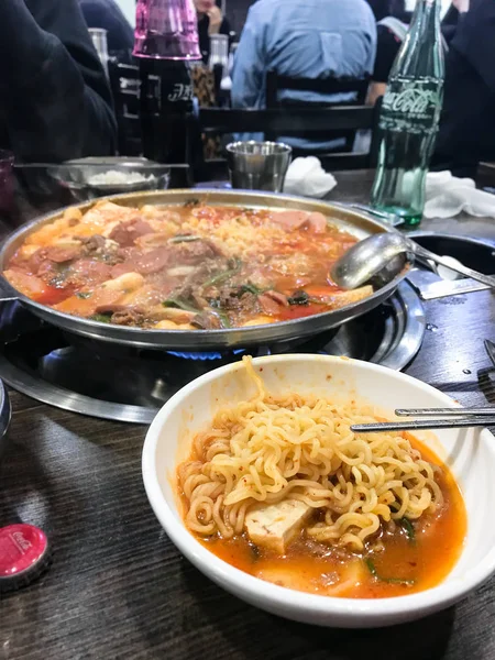 Eating soup with ramen noodles in korean eatery — Stock Photo, Image