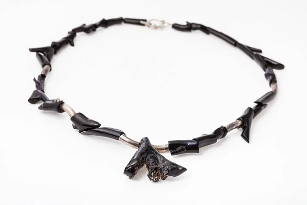 Necklace from polished black coral twigs on white — Stock Photo, Image