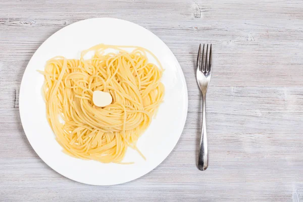 Pasta on white plate and fork with copyspace — Stock Photo, Image