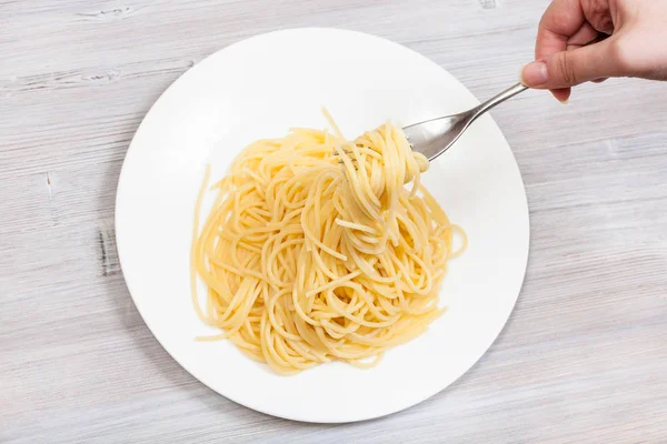 Top view fork with spaghetti over white plate — Stock Photo, Image