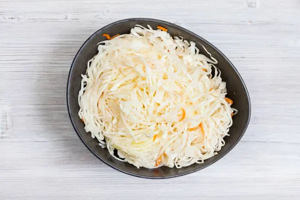 Top view of Russian sauerkraut in bowl on gray — Stock Photo, Image