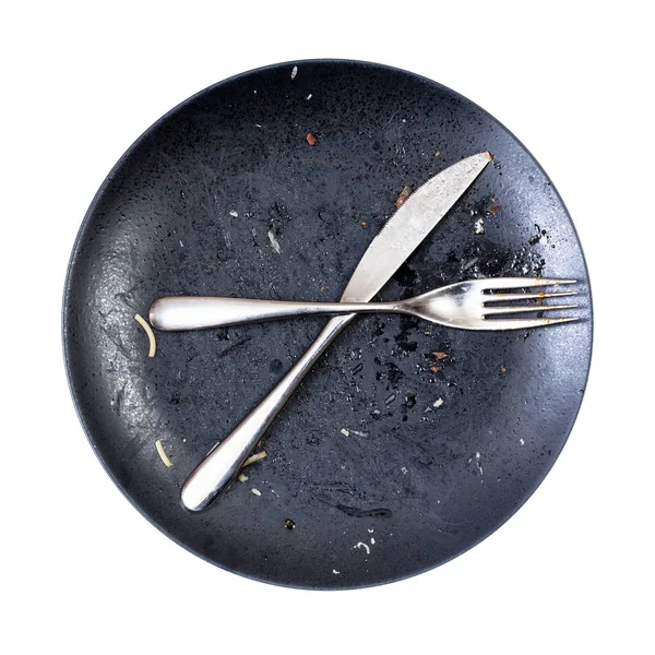 Crossed knife and fork on dirty plate after lunch — Stock Photo, Image