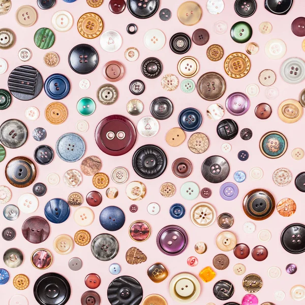 Many various buttons on pink background — Stock Photo, Image