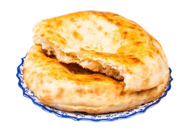 one and half tandoor uzbek breads ( non) on plate clipart