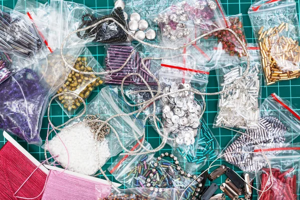 Various embroidery items on cutting mat close up — Stock Photo, Image