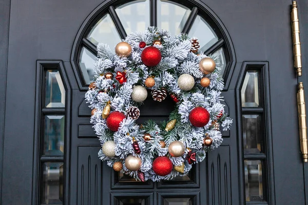 outdoor advent wreath on front door on city street in winter