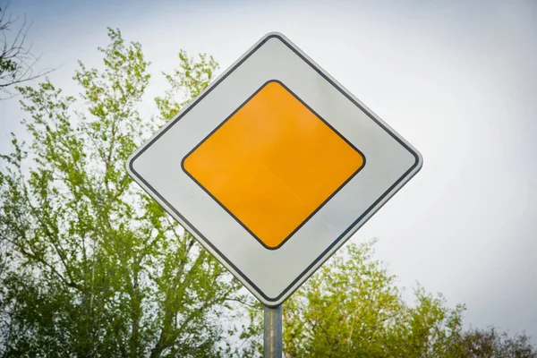 sign main road and tree branches