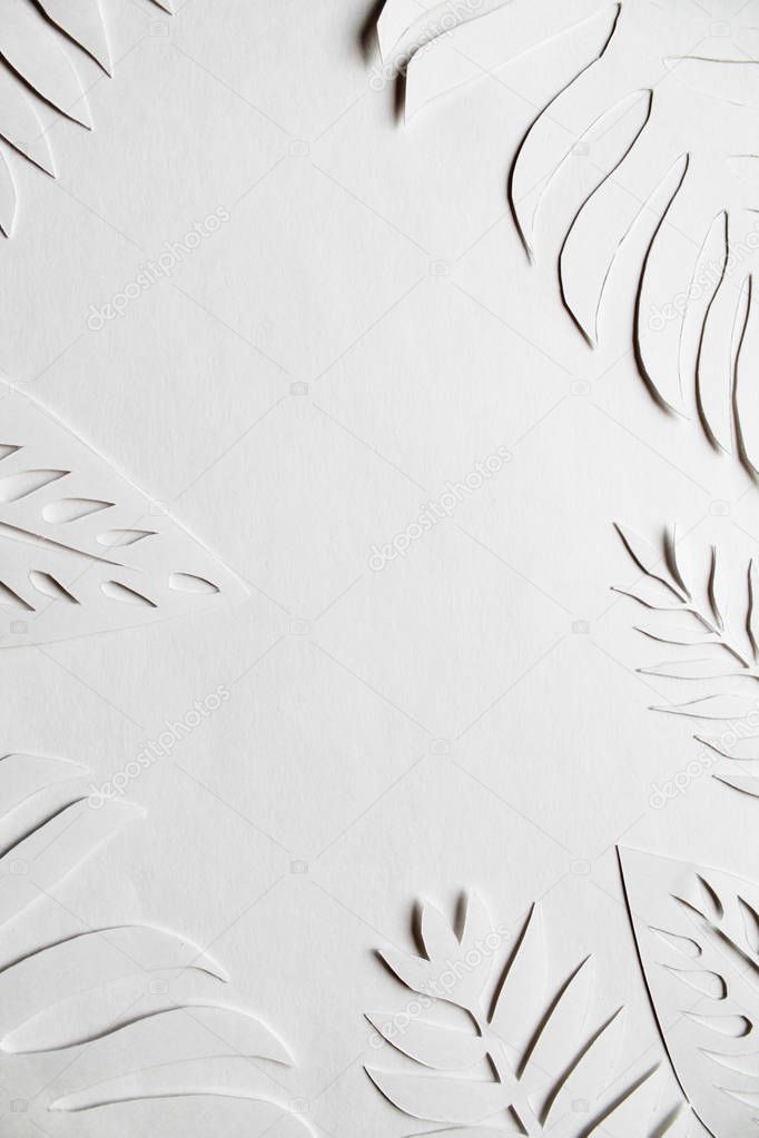 White paper cut leaves on the white background. 