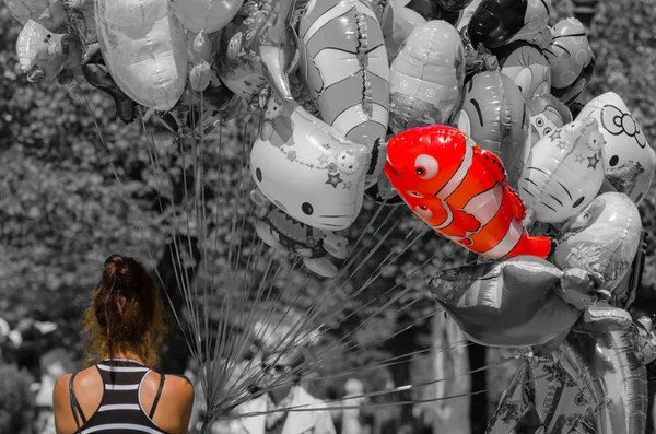 Woman and a colorful balloon with gray — Stock Photo, Image