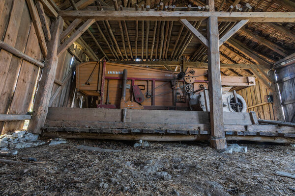 wooden threshing machine in abandoned house