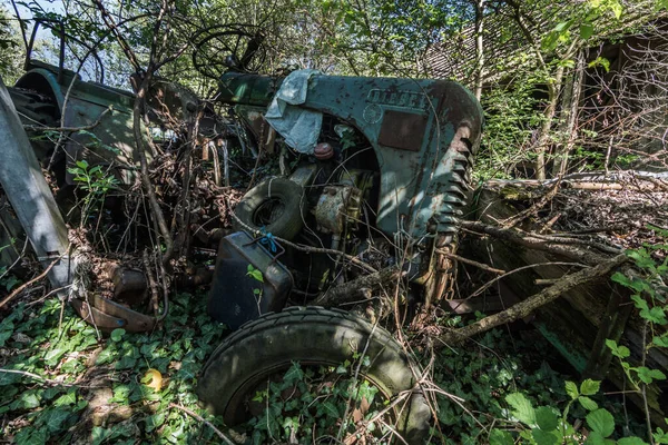 Trator azul quebrado perto de uma fazenda — Fotografia de Stock