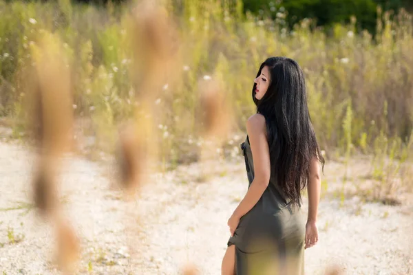 Dreaming woman enjoying the life in the field. Nature beauty, colorful field, fashion woman. Outdoor lifestyle. Freedom concept