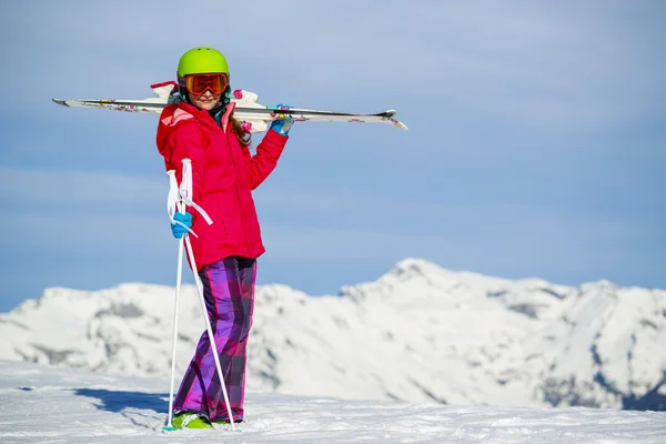 Dziewczyna stoi z nart na ramionach na świeżym śniegu w proszku na s — Zdjęcie stockowe