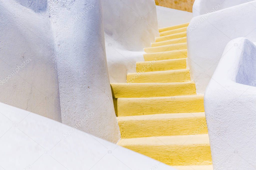 yellow stairs among white houses