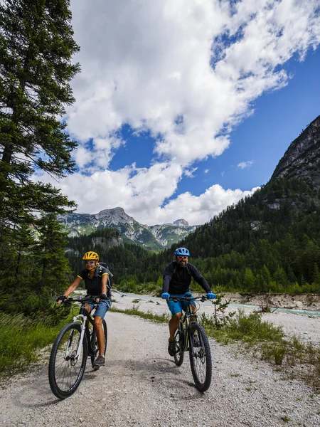 Mountain biking couple in Dolomites