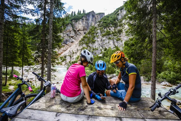 Family rides bikes in the mountains