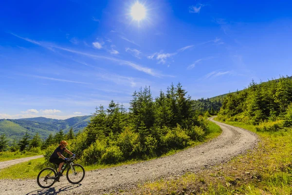 Mountain biking women riding on bike in early spring mountains f — Stock Photo, Image