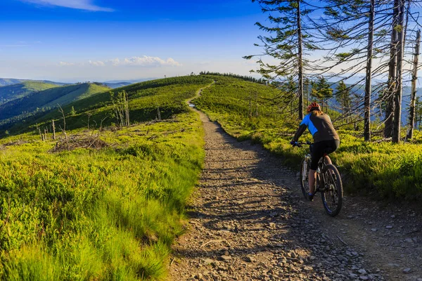 Mountain biking women riding on bike in early spring mountains f — Stock Photo, Image