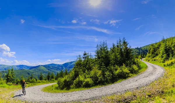 Mountain biking women riding on bike in summer mountains forest — Stock Photo, Image