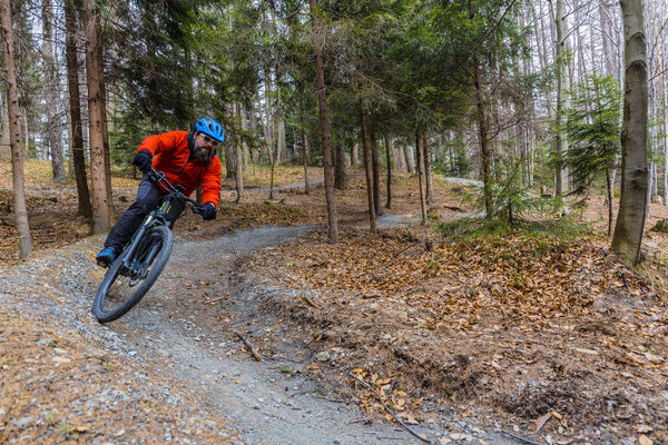 Mountain biker riding on bike in early spring mountains forest l