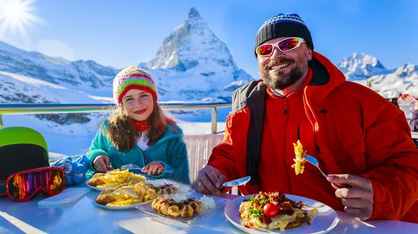 Vacaciones de esquí de invierno - esquiadores disfrutando de un descanso para el almuerzo, montaña —  Fotos de Stock