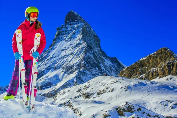 Portrait of happy young girl in the snow, ski slope and Matterho — Stock Photo, Image