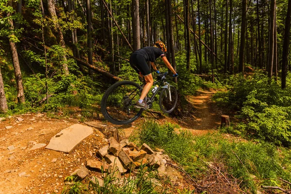 Mountain biking woman riding on bike in summer mountains forest — Stock Photo, Image