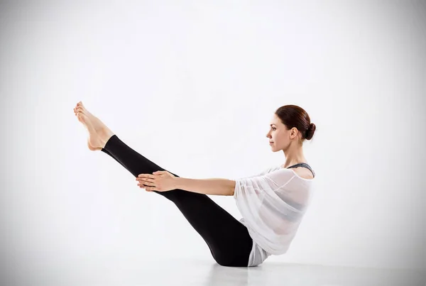 Young woman doing yoga exercise on the floor. — Stock Photo, Image